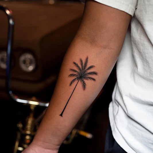 Small Blackwork Palm Tree Tattoo on Men Arm by @sebastian_tattoo