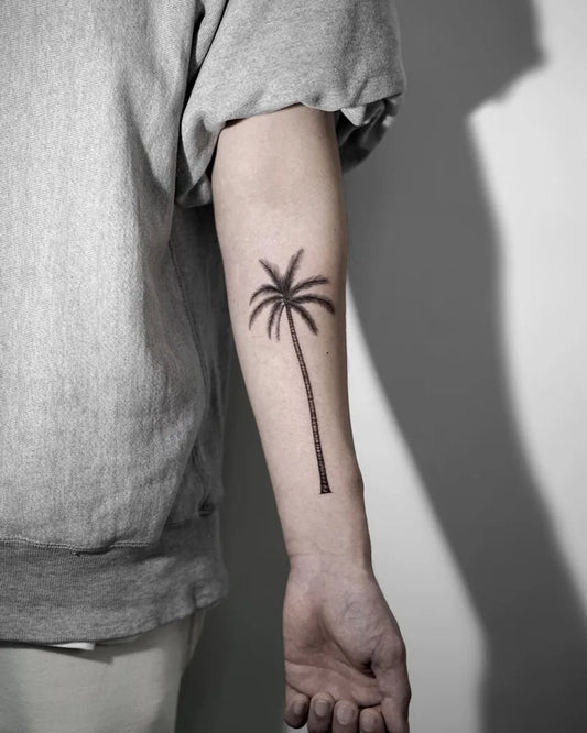 Small Blackwork Palm Tree Tattoo on Men Arm by @z9_ttt