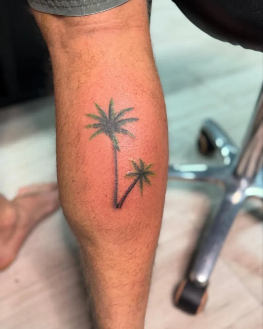 Small Blackwork Palm Tree Tattoo on Men Leg by @sheribella.tattoo