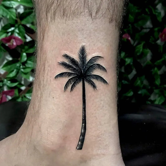 Small Blackwork Palm Tree Tattoo on Men Leg by @yantinotattoo_ubud