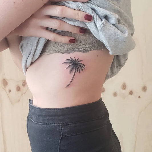Small Blackwork Palm Tree Tattoo on Women Rib by @tattoosbyjoelv