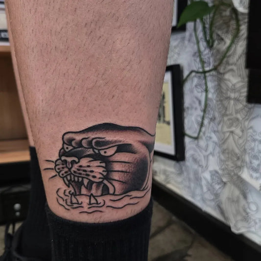 Small Blackwork Panther Tattoo on Men Leg by @mitchpleasance