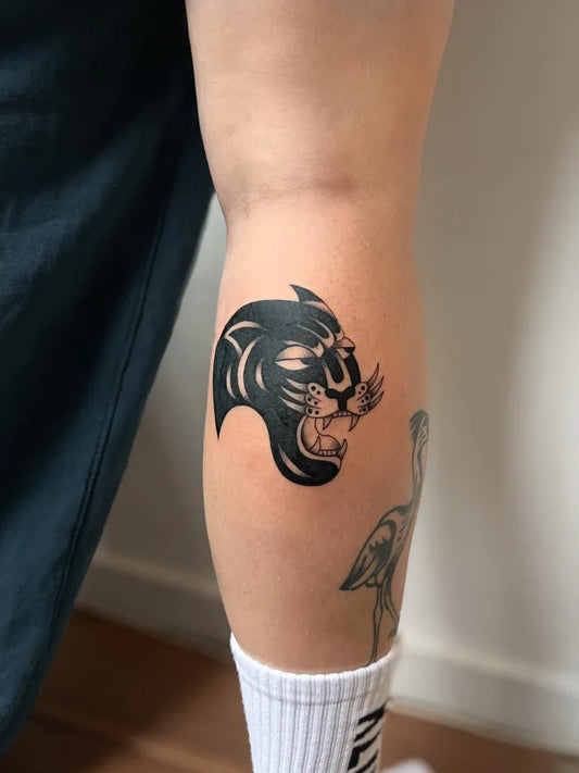 Small Blackwork Panther Tattoo on Women Leg by @donnie.tattoos