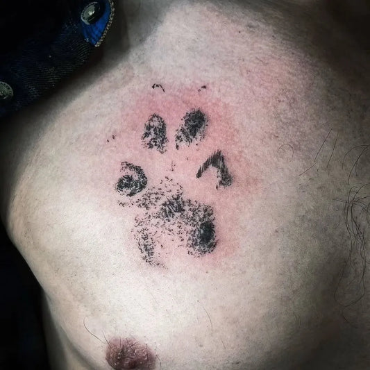 Small Blackwork Paw Print Tattoo on Men Neck by @bigjoeandsonstattoo