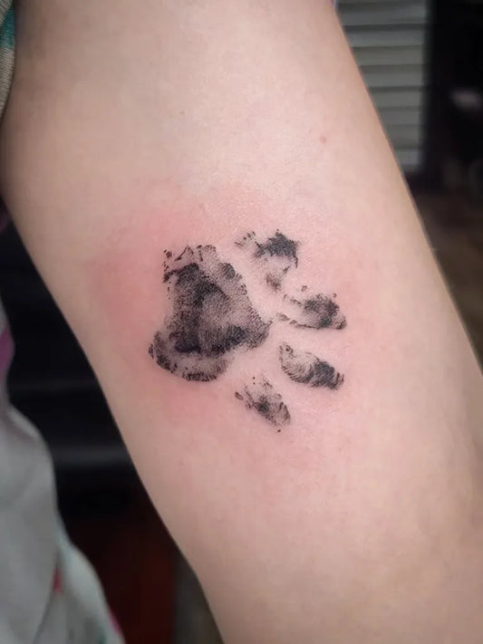 Small Blackwork Paw Print Tattoo on Women Arm by @vexsyx