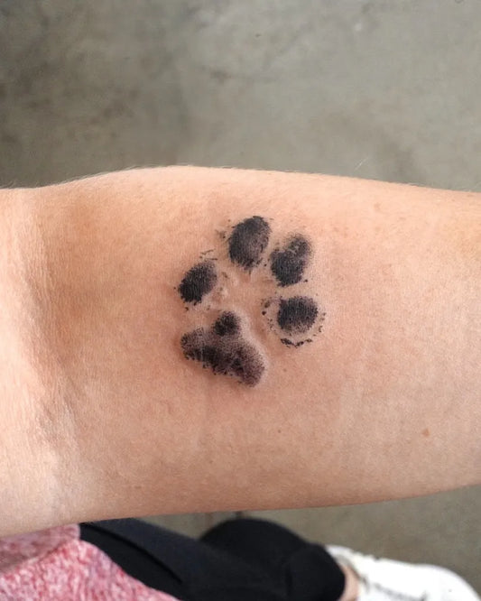 Small Blackwork Paw Print Tattoo on Women Forearm by @tattooist_kimria