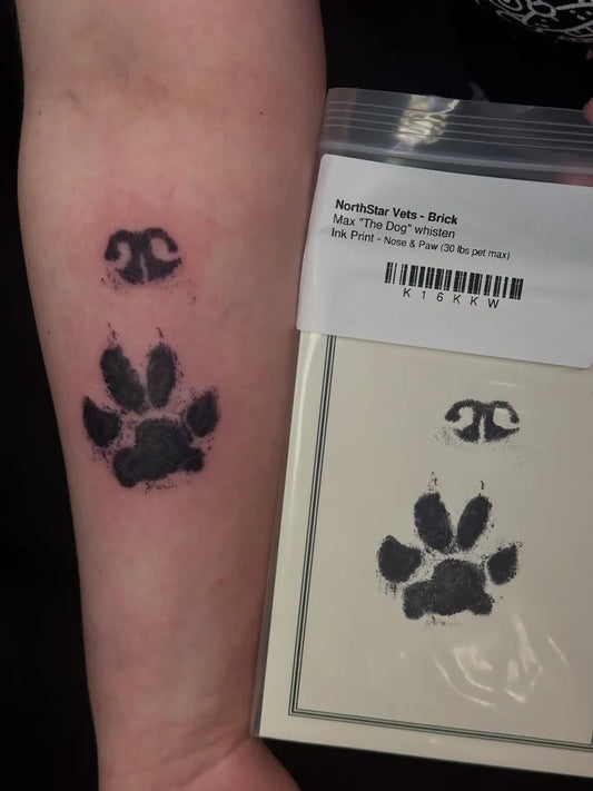 Small Blackwork PawPrint and CollarTag Tattoo on Women Arm by @radiantenergytattoo