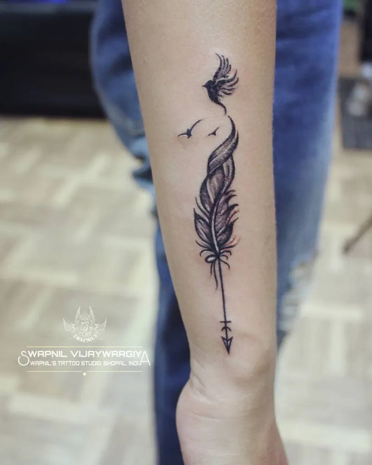 Small Blackwork Phoenix Arrow Tattoo on Women Wrist by @swapnils_tattoo_studio