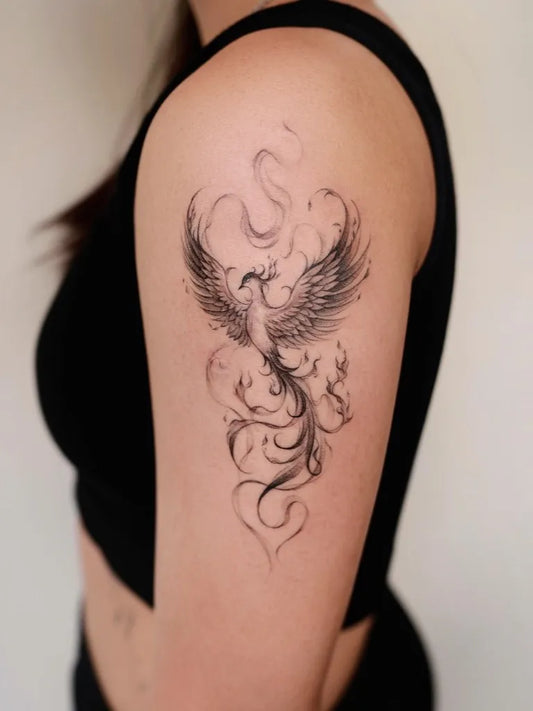 Small Blackwork Phoenix on Women Shoulder Tattoo by @soap.tattoo