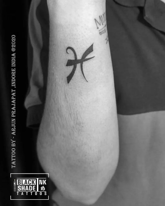 Small Blackwork Pisces Symbol Tattoo on Men Arm by @arjunnprajapat
