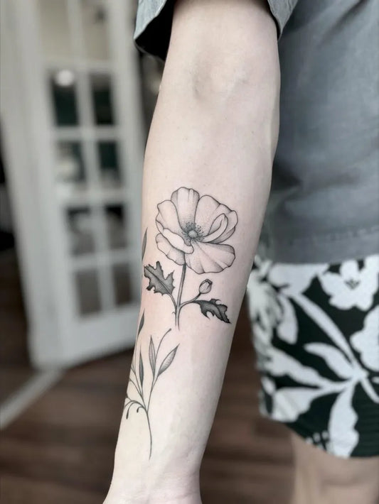 Small Blackwork Poppy Flower Tattoo on Women Arm by @tessameliaa