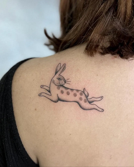 Small Blackwork Rabbit Tattoo on Women Shoulder by @shanhantattoo