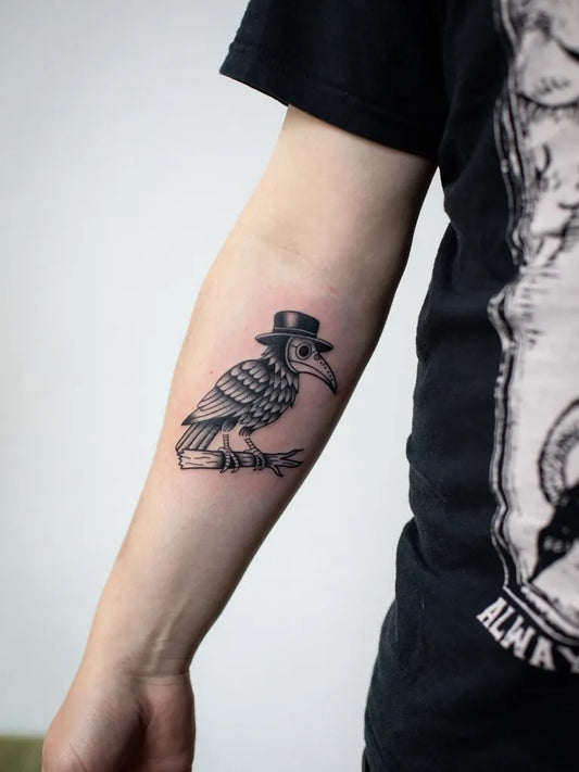 Small Blackwork Raven in Plague Doctor Mask on Men Arm Tattoo by @annedekkertattoo