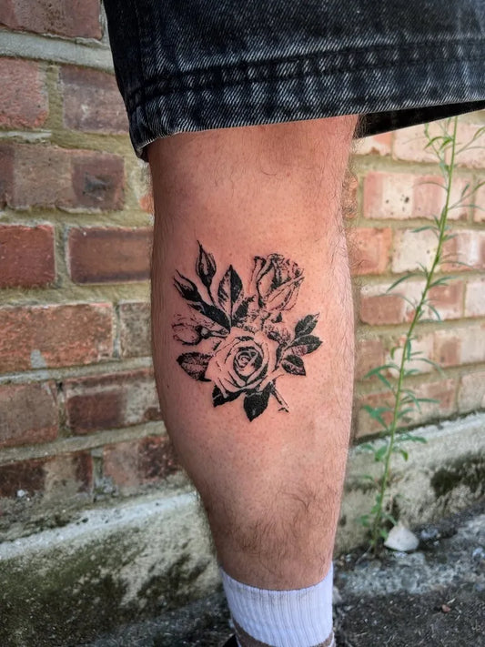 Small Blackwork Rose Bouquet on Men Calf Tattoo by @joeboy.tattoo