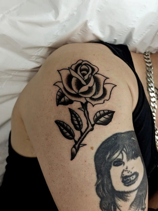 Small Blackwork Rose and Face on Women Shoulder Tattoo by @tomwaco