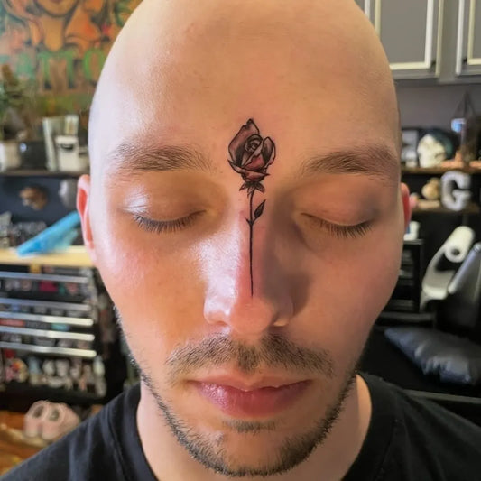 Small Blackwork Rose on Men Face Tattoo by @tjrtattoos
