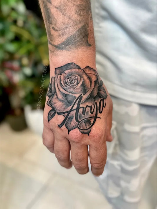 Small Blackwork Rose with Arya on Men Hand Tattoo by @jina.gwansoontattoos