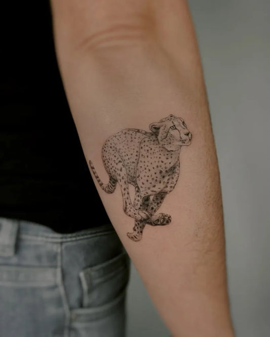 Small Blackwork Running Cheetah Animal Tattoo on Women Arm by @majola.tattoo