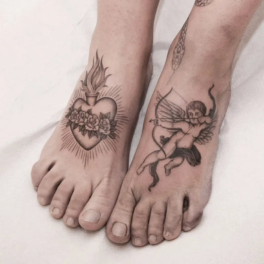 Small Blackwork Sacred Heart and Cupid Tattoo on Women Foot by @aitoririmia