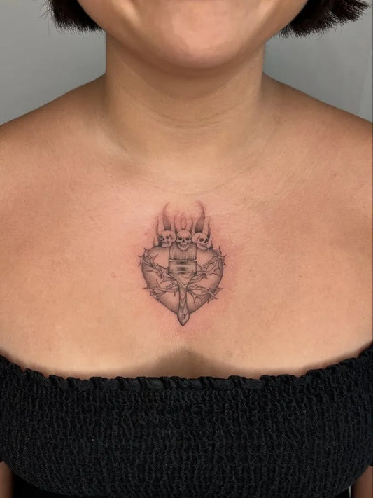 Small Blackwork Sacred Heart with Horns Tattoo on Women Chest by @tesnusa