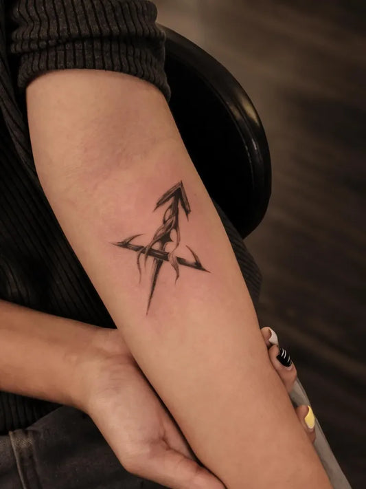 Small Blackwork Sagittarius Symbol Tattoo on Women Arm by @spooy.w