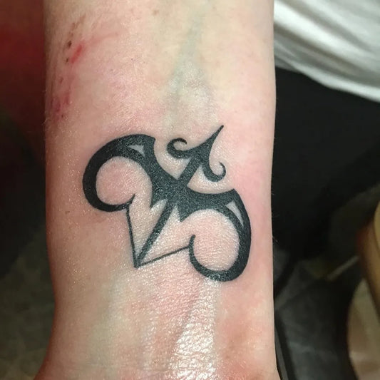 Small Blackwork Sagittarius Symbol Tattoo on Women Wrist by @truecustomtattoo