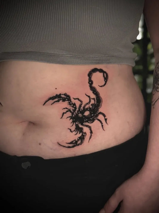 Small Blackwork Scorpion on Women Abdomen Tattoo by @andrei.urvik