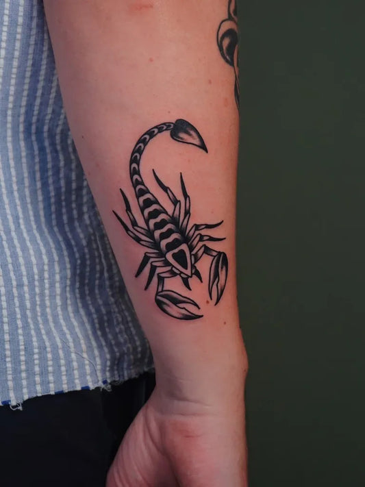 Small Blackwork Scorpion on Women Arm Tattoo by @figtree.tattoo.studio