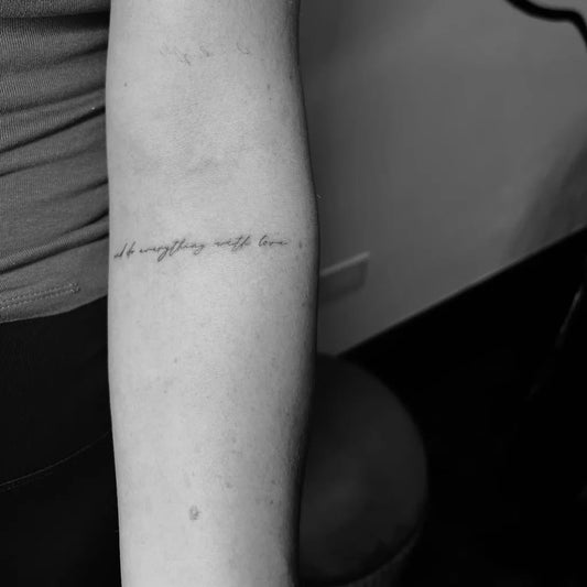 Small Blackwork Script Quote Tattoo on Women Arm by @salon_halo.ink