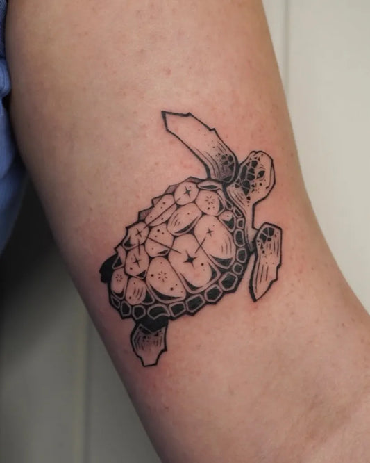 Small Blackwork Sea Turtle Tattoo on Women Arm by @scaredy.cat.tatts