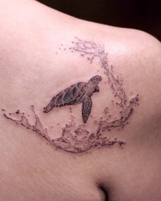 Small Blackwork Sea Turtle and Waves Tattoo on Women Shoulder by @eggsy_tattoo