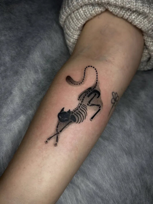 Small Blackwork Skeleton Cat Tattoo on Women Forearm by @makakerttt