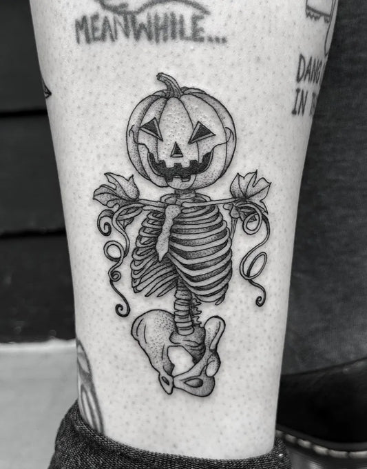 Small Blackwork Skeleton Pumpkin Halloween Tattoo on Women Leg by @breezytucker