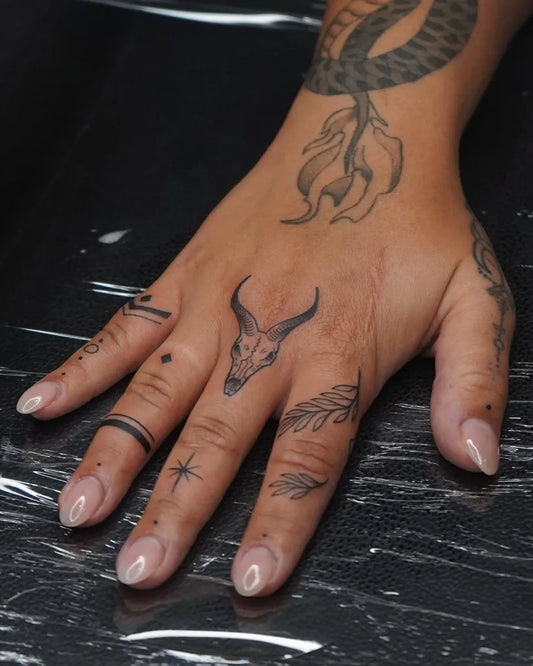 Small Blackwork Skull Serpent Leaves on Women Fingers Tattoo by @isa__ttt