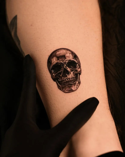 Small Blackwork Skull on Men Arm Tattoo by @amila.ink