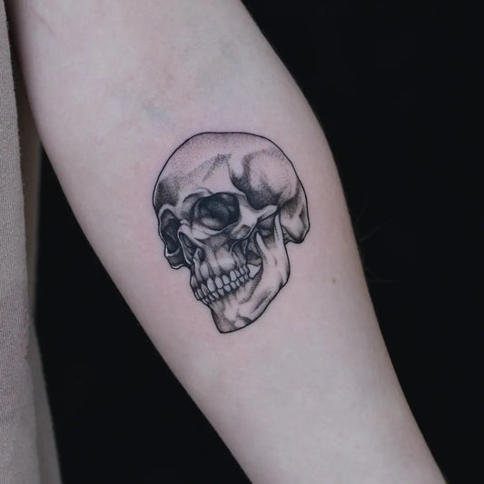 Small Blackwork Skull on Women Arm Tattoo by @laduca_art