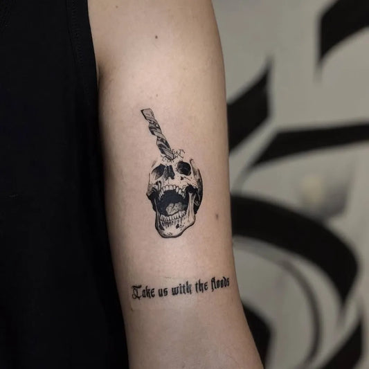 Small Blackwork Skull with Candy Stick on Men Arm Tattoo by @birol_tattoo