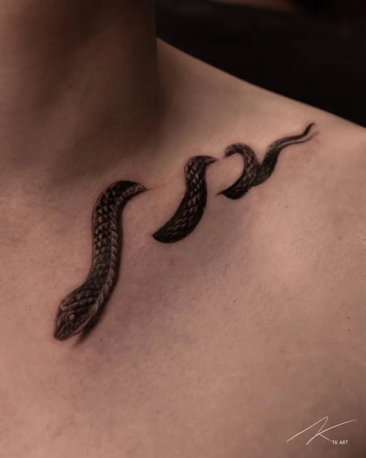 Small Blackwork Snake Tattoo on Men Collarbone by @tattooist_tk
