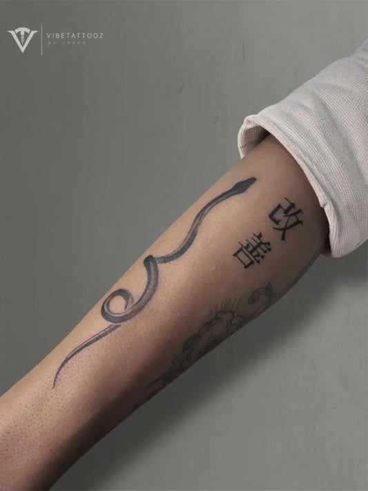 Small Blackwork Snake and Chinese Characters on Women Arm Tattoo by @vibetattooz