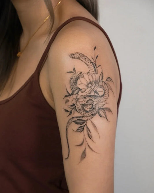 Small Blackwork Snake and Flowers on Women Shoulder Tattoo by @mandychan.t