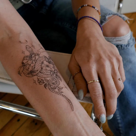Small Blackwork Snake and Lotus on Women Arm Tattoo by @christinepexin