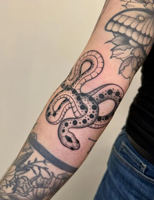 Small Blackwork Snake and Moth on Women Arm Tattoo by @cats.and.tat.s
