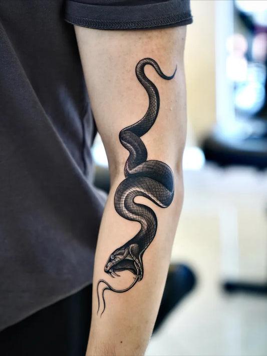 Small Blackwork Snake on Men Arm Tattoo by @baronarttattoo