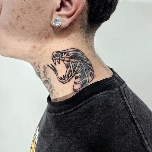 Small Blackwork Snake on Men Neck Tattoo by @yurisertain.tattoo