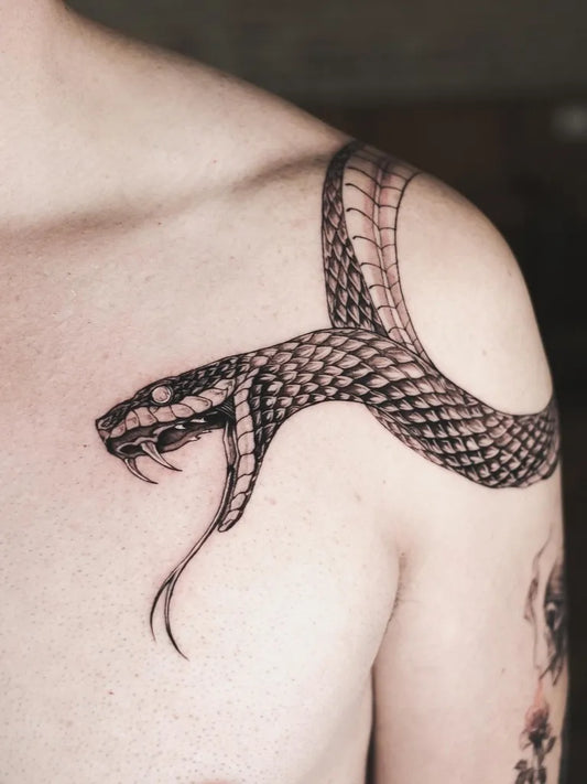 Small Blackwork Snake on Men Shoulder Tattoo by @david.arato