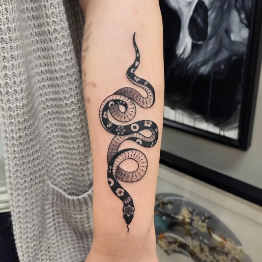 Small Blackwork Snake on Women Arm Tattoo by @ianw_tattoo