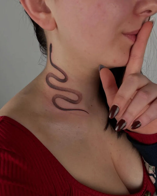 Small Blackwork Snake on Women Neck Tattoo by @zuzarteink