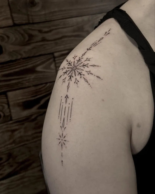Small Blackwork Snowflakes Tattoo on Women Shoulder by @alinatatts
