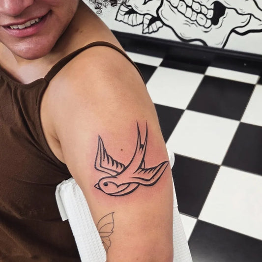 Small Blackwork Sparrow Tattoo on Women Shoulder by @berryblues