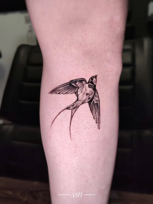 Small Blackwork Sparrow Tattoo on Women Thigh by @ashtattooart